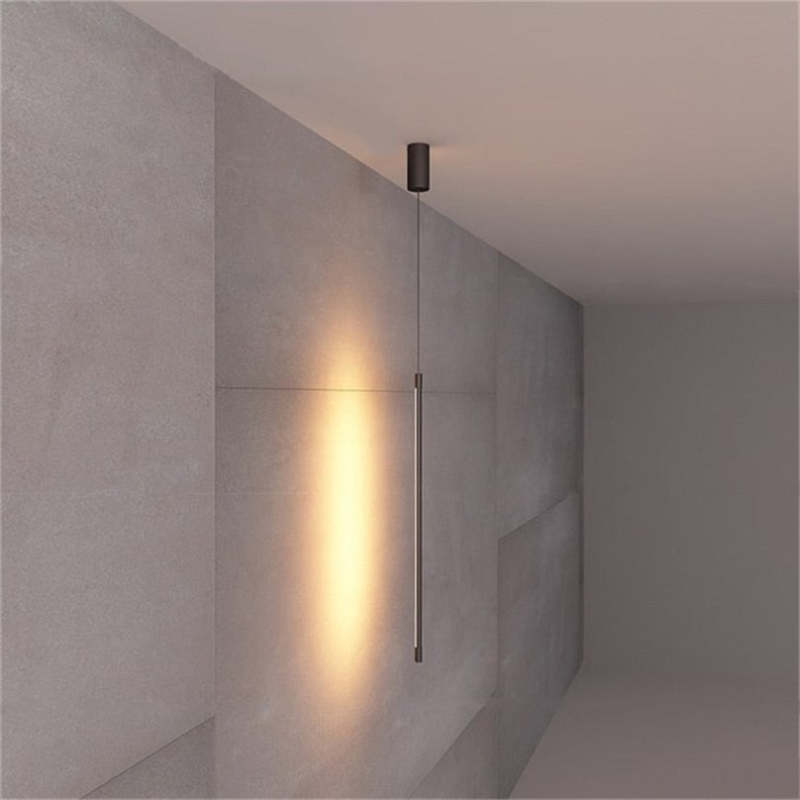 Minimalistyczna liniowa lampa wisząca LED przy łóżku