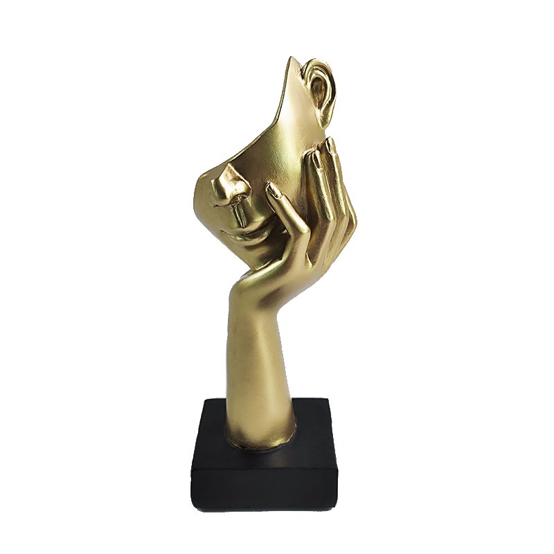 Sculptural hand holding a face mask