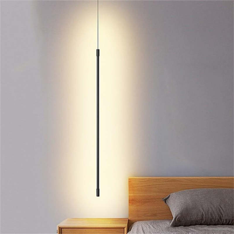 Minimalistyczna liniowa lampa wisząca LED przy łóżku