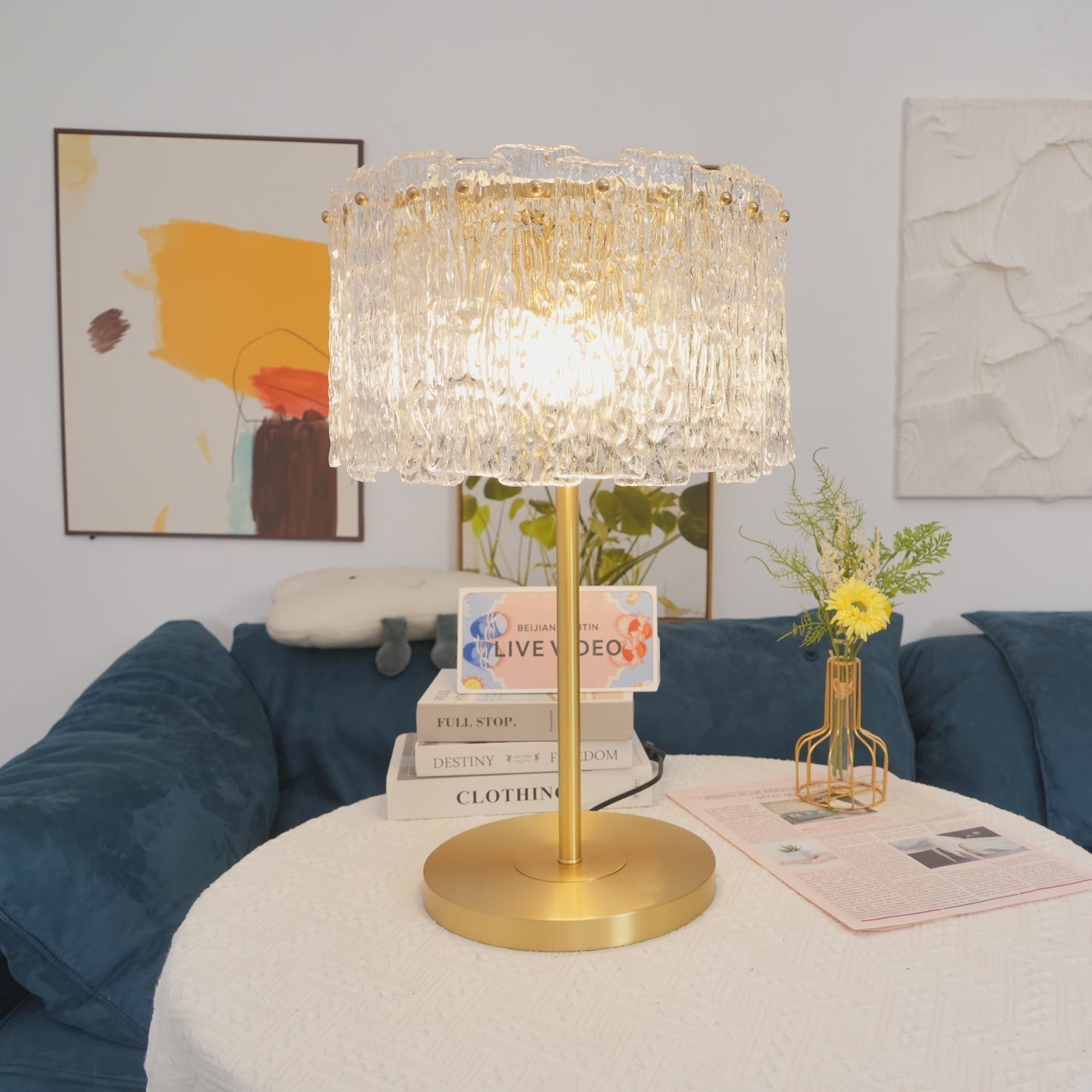Table lamp with faceted transparent shade and round base