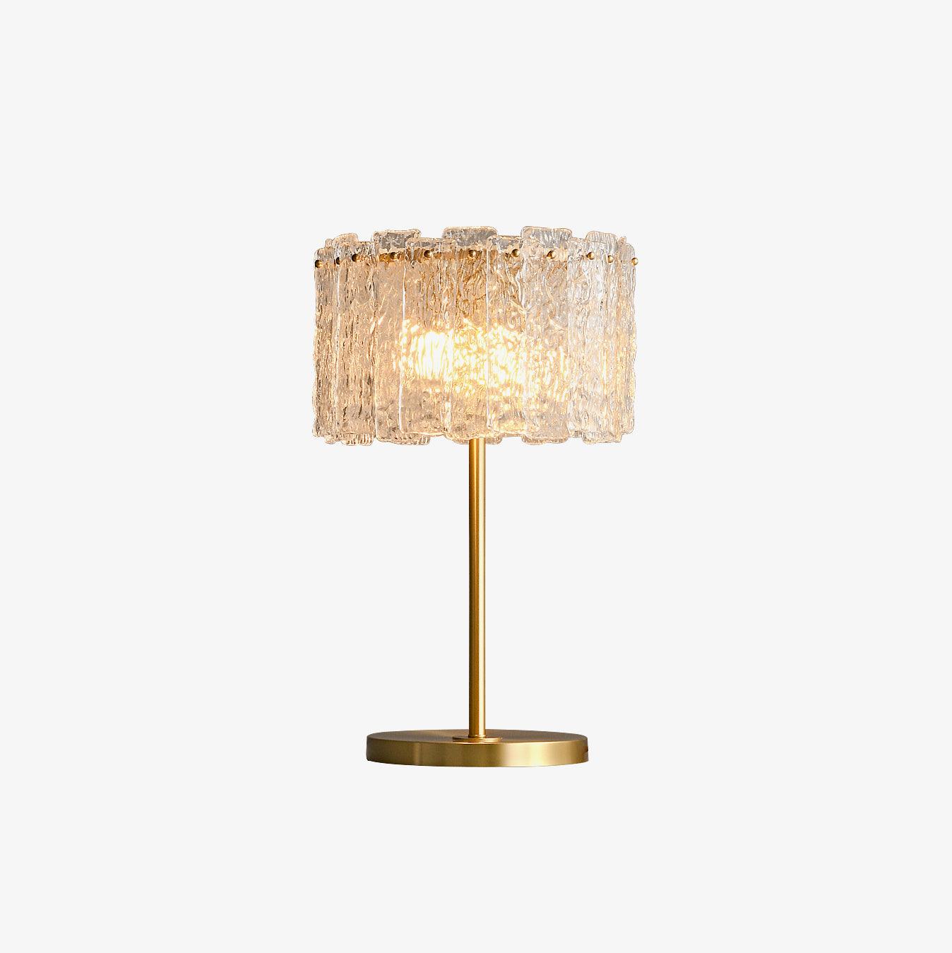 Table lamp with faceted transparent shade and round base