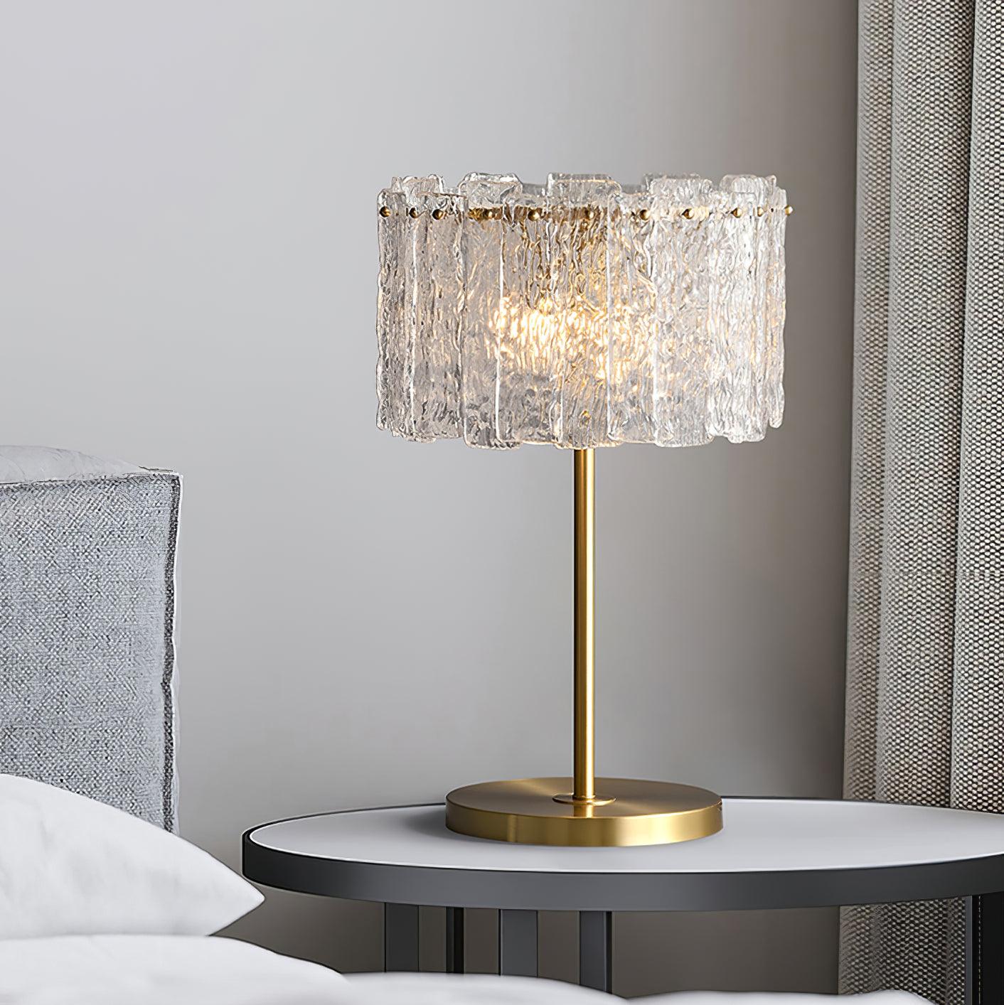Table lamp with faceted transparent shade and round base