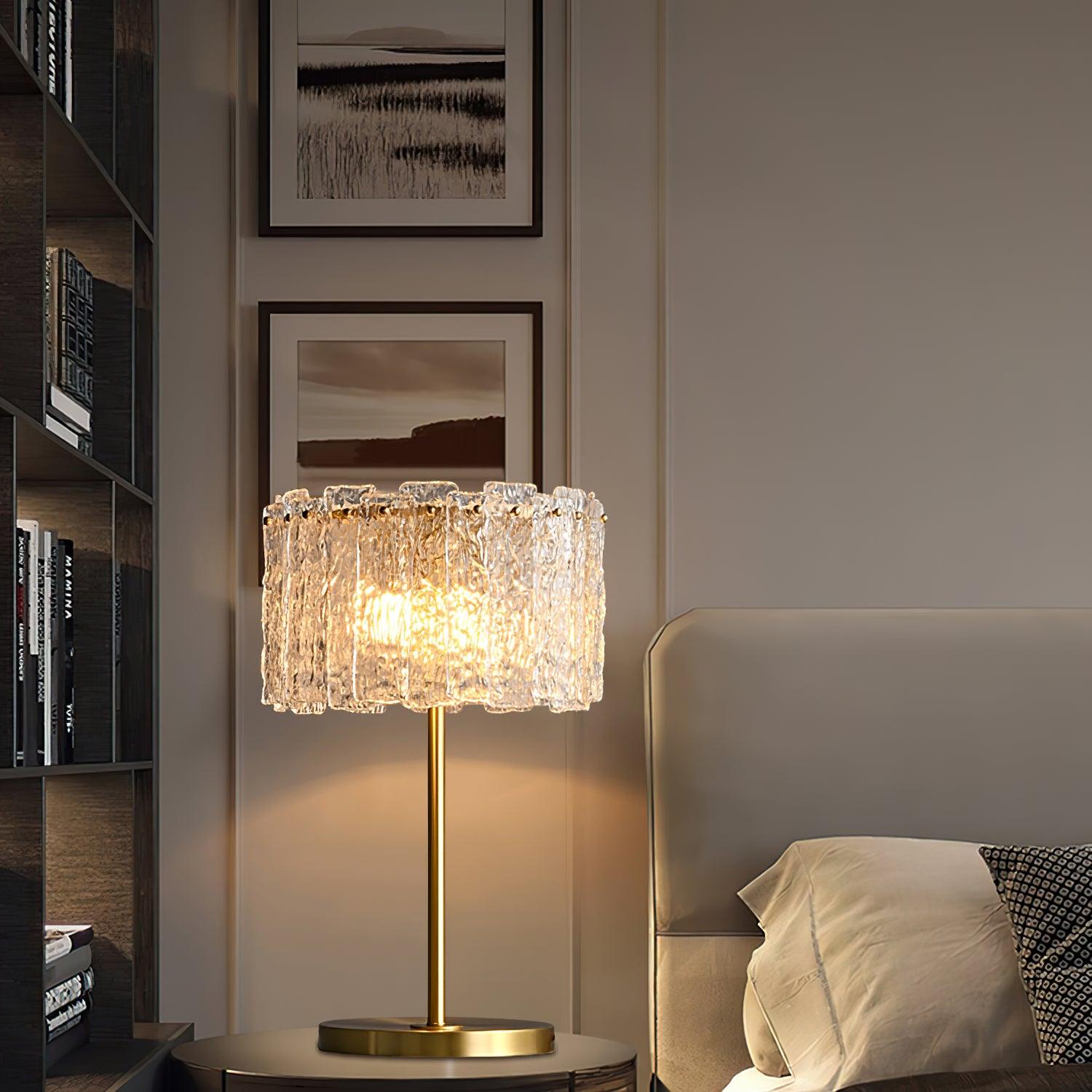 Table lamp with faceted transparent shade and round base