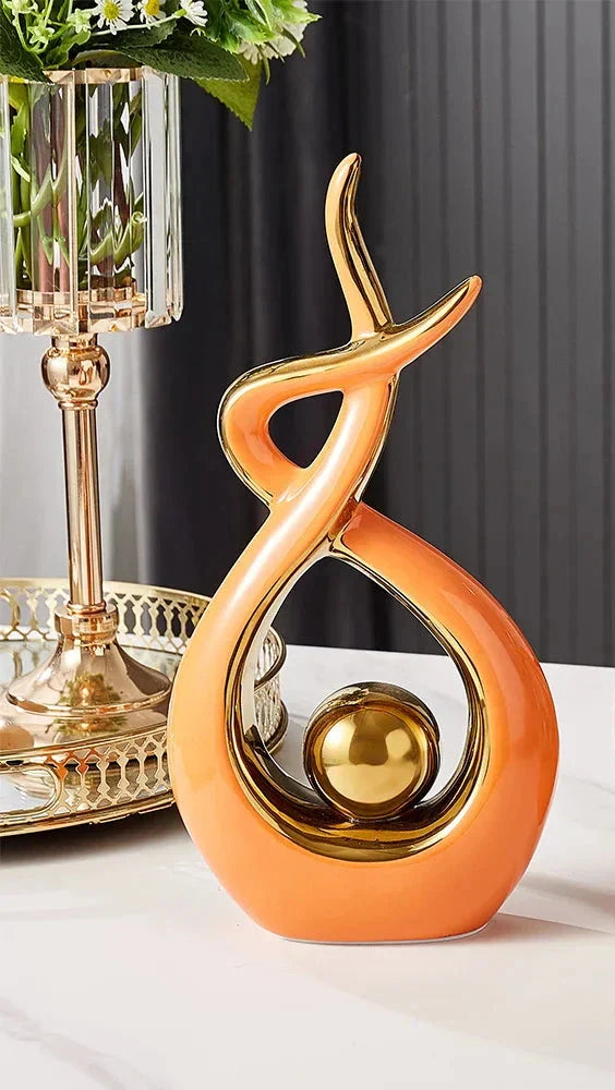 Ceramic abstract figurine with golden sphere
