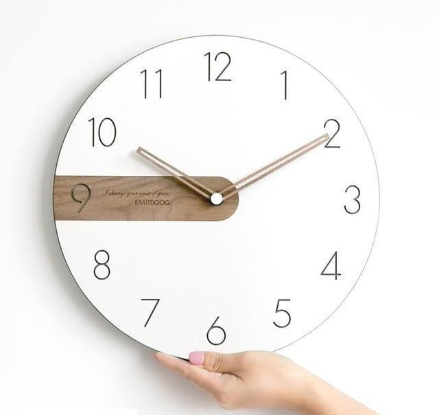 Round wall clock with white dial and wooden element