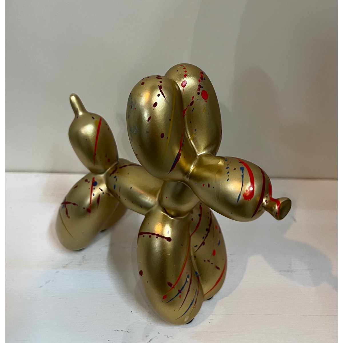 Balloon dog figurine with colorful spotted surface