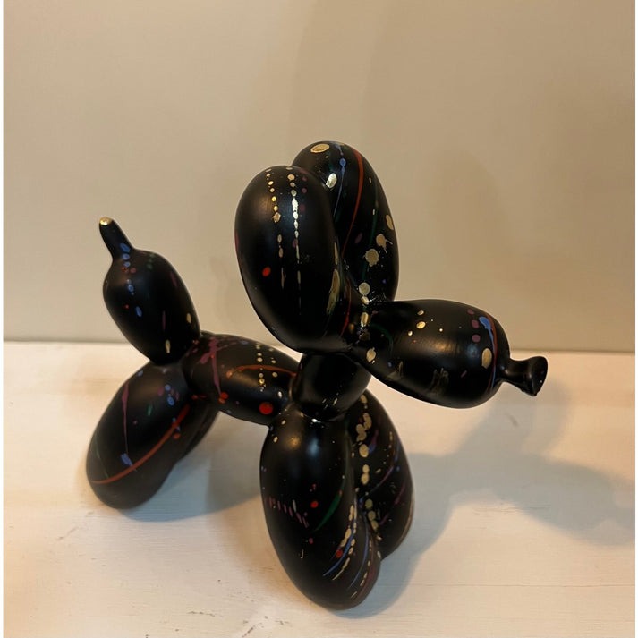 Balloon dog figurine with colorful spotted surface