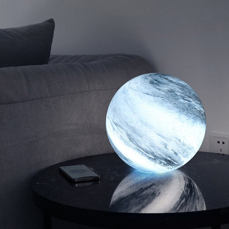 Glass LED table lamp inspired by the moon with cosmic pattern