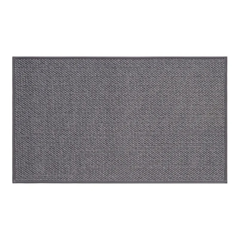 Woven floor mat with textured surface and backing