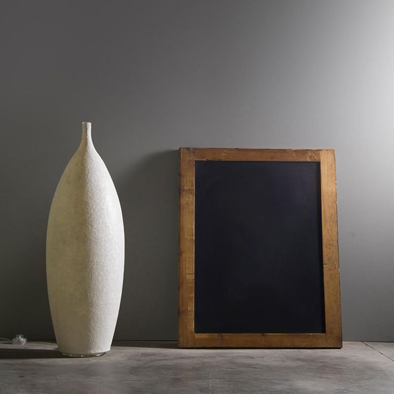 Floor lamp shaped like a bottle with textured surface