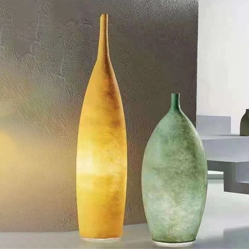 Floor lamp shaped like a bottle with textured surface