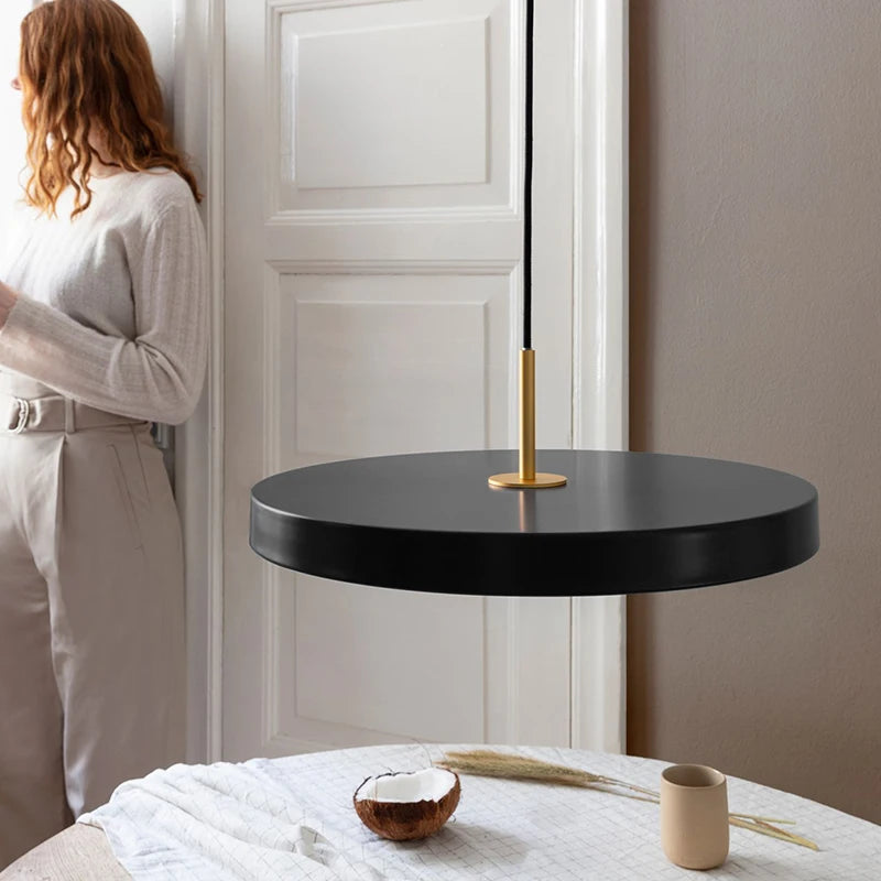 Modern pendant light with a flat disk-shaped shade