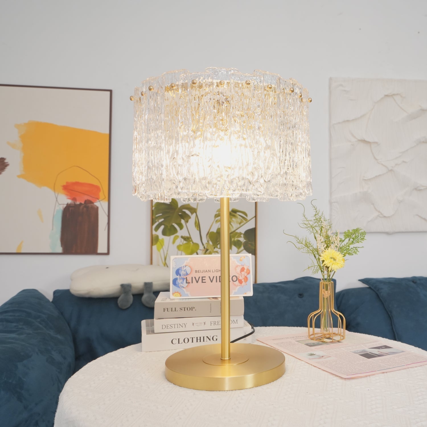 Table lamp with faceted transparent shade and round base