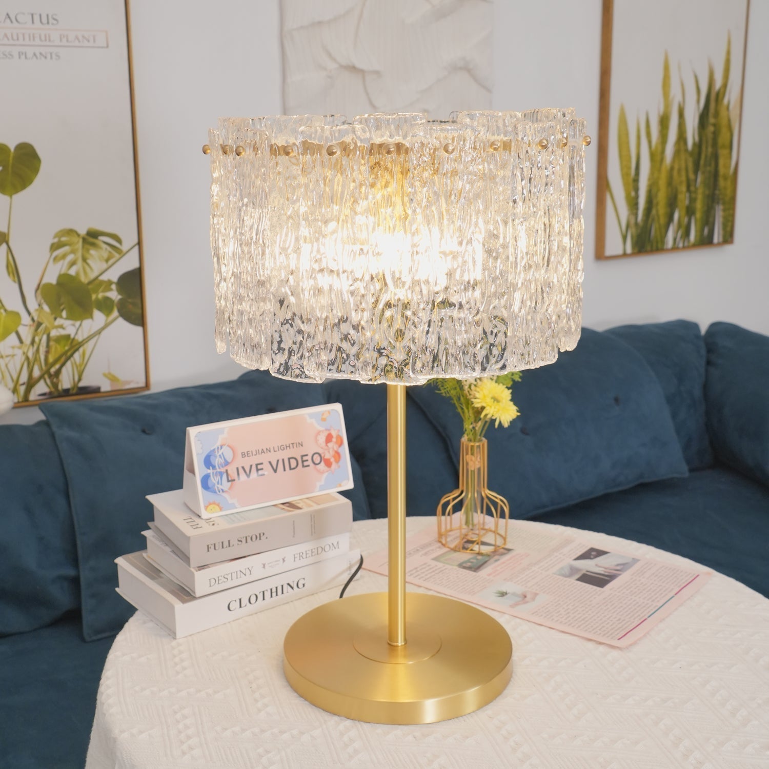Table lamp with faceted transparent shade and round base