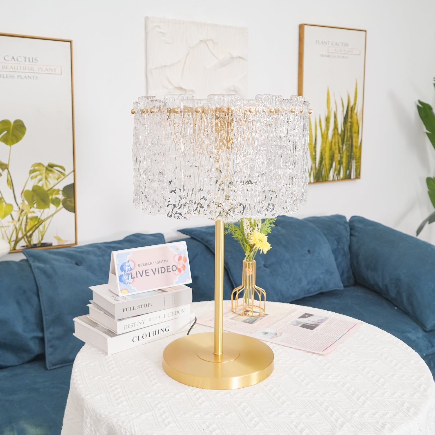Table lamp with faceted transparent shade and round base