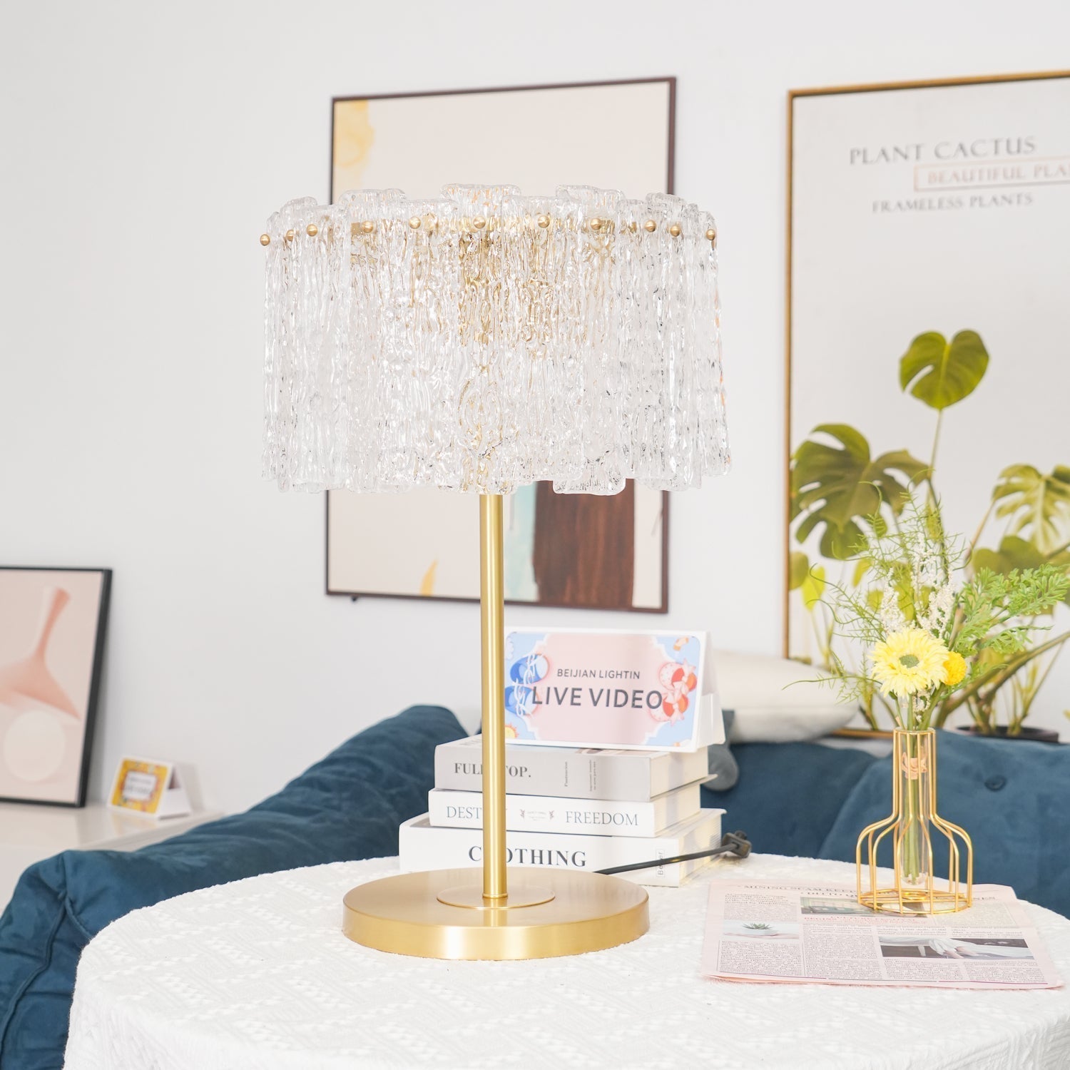 Table lamp with faceted transparent shade and round base