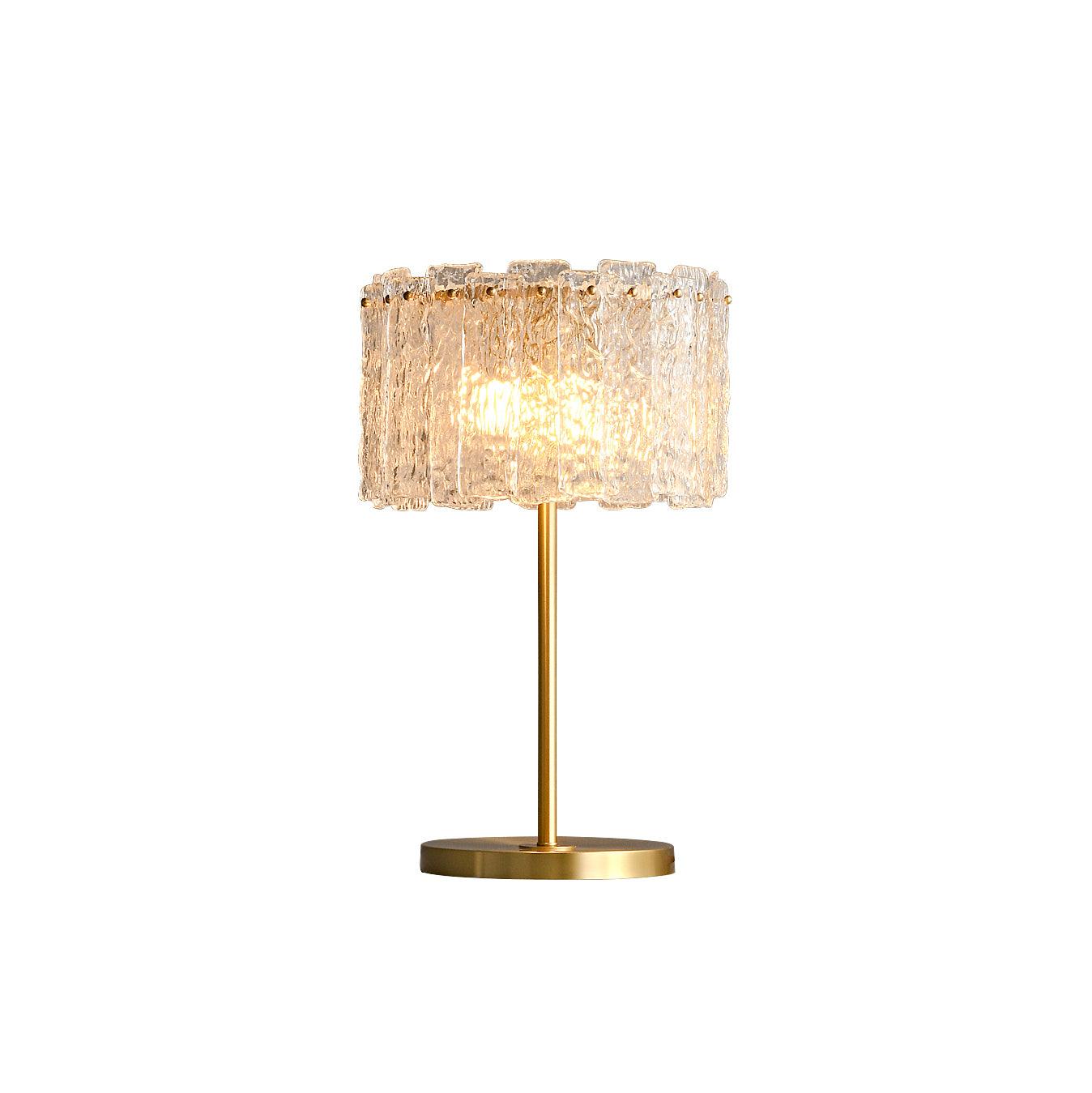 Table lamp with faceted transparent shade and round base