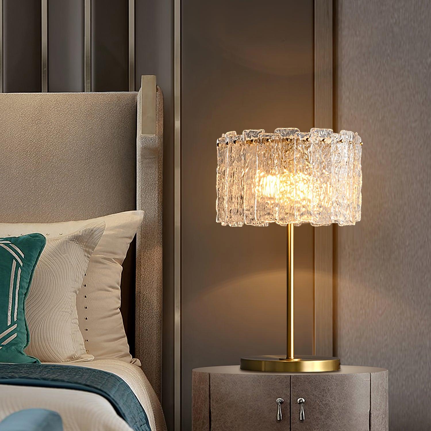 Table lamp with faceted transparent shade and round base