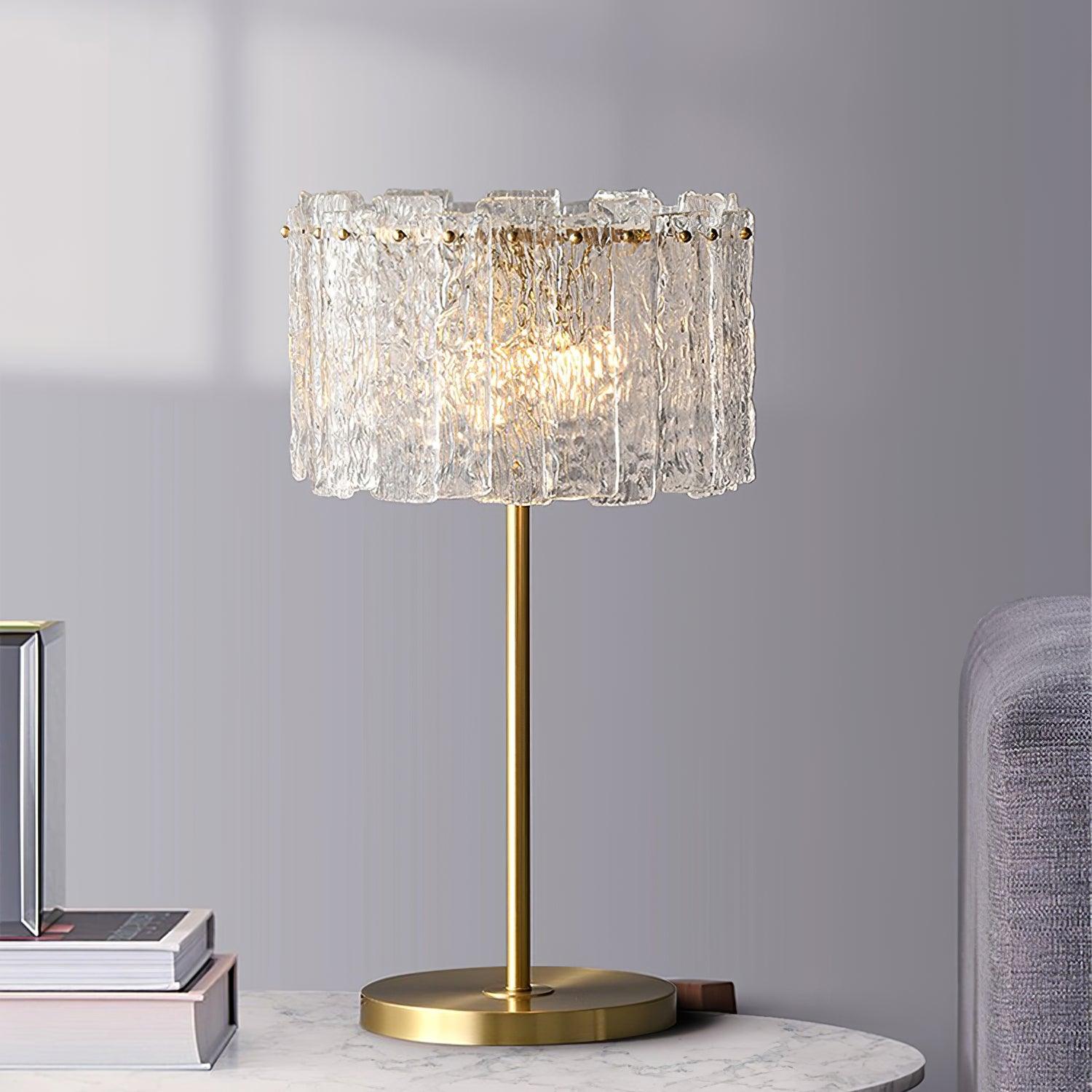 Table lamp with faceted transparent shade and round base
