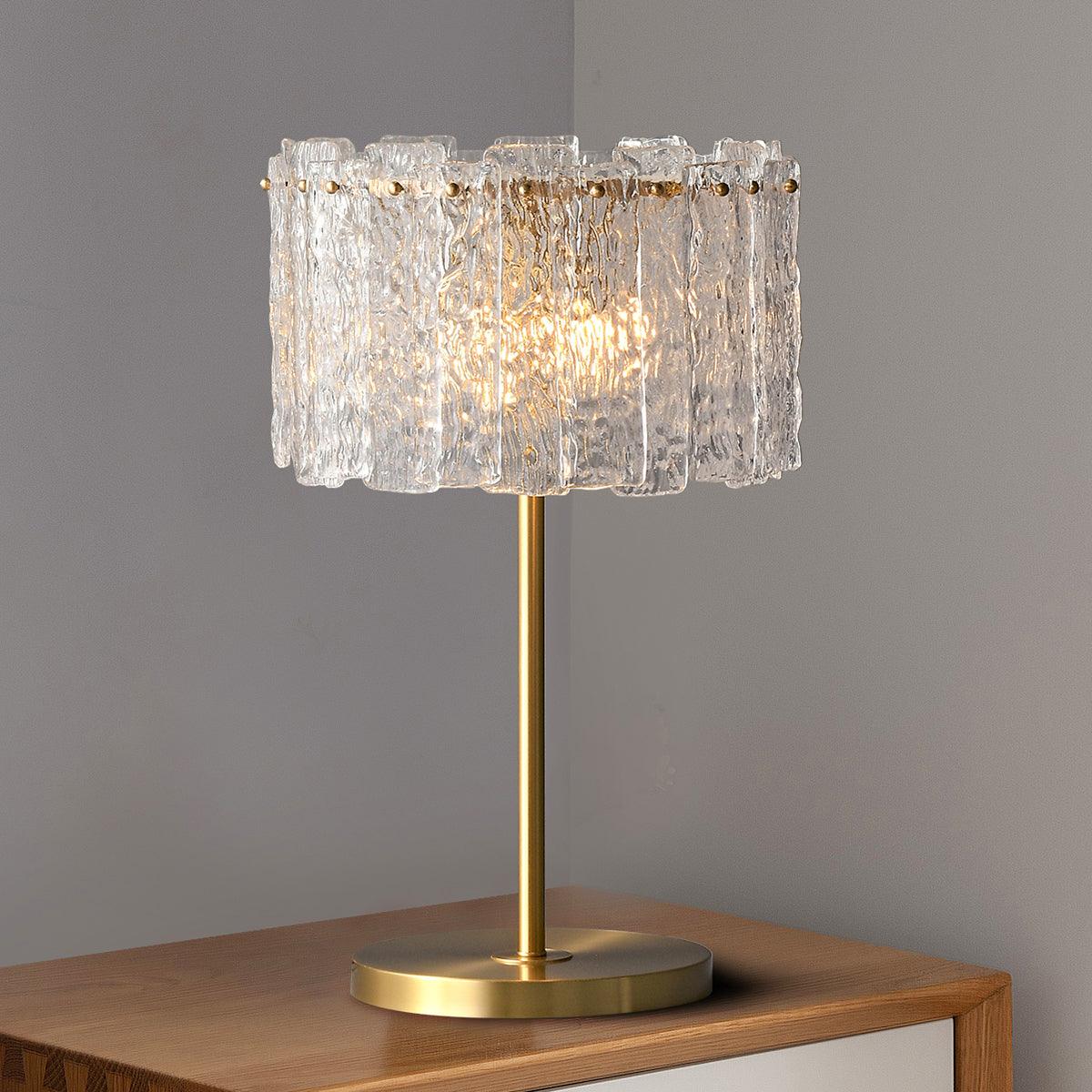 Table lamp with faceted transparent shade and round base