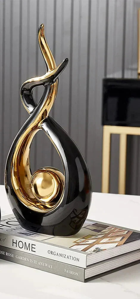 Ceramic abstract figurine with golden sphere
